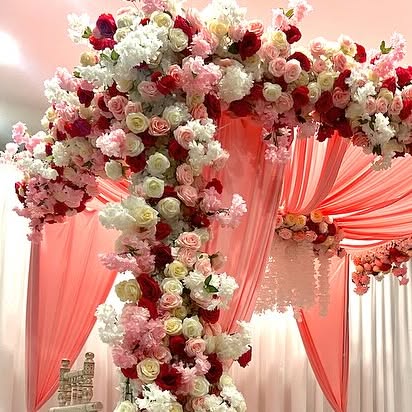 Pink, blue, and white drape wedding stage above a custom dance floor